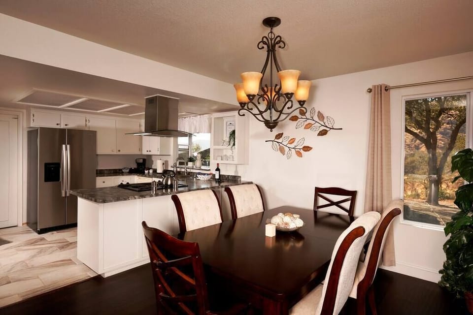 Large dining table with the updated kitchen.
