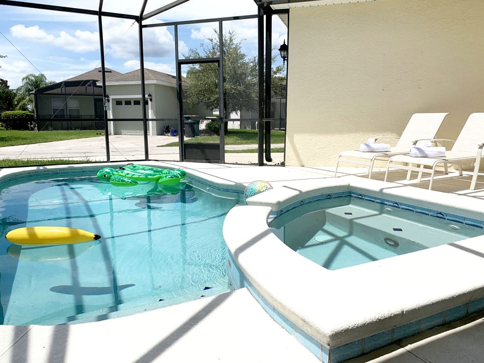 Pool area showing spa and sun loungers