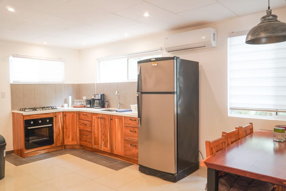 full kitchen with full size fridge, stove top and oven