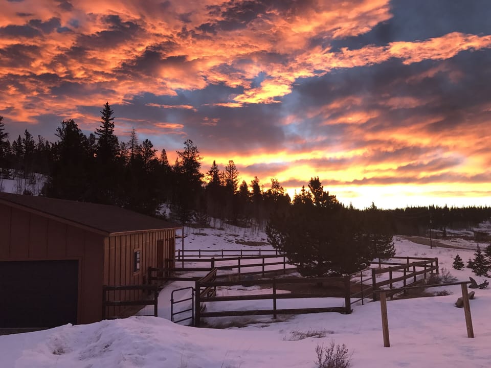 sunrise over the barn and corral
