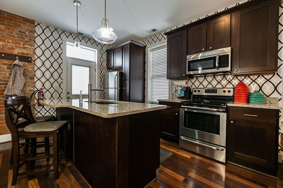 Fully stocked, kitchen with granite countertops and stainless steel appliances. 