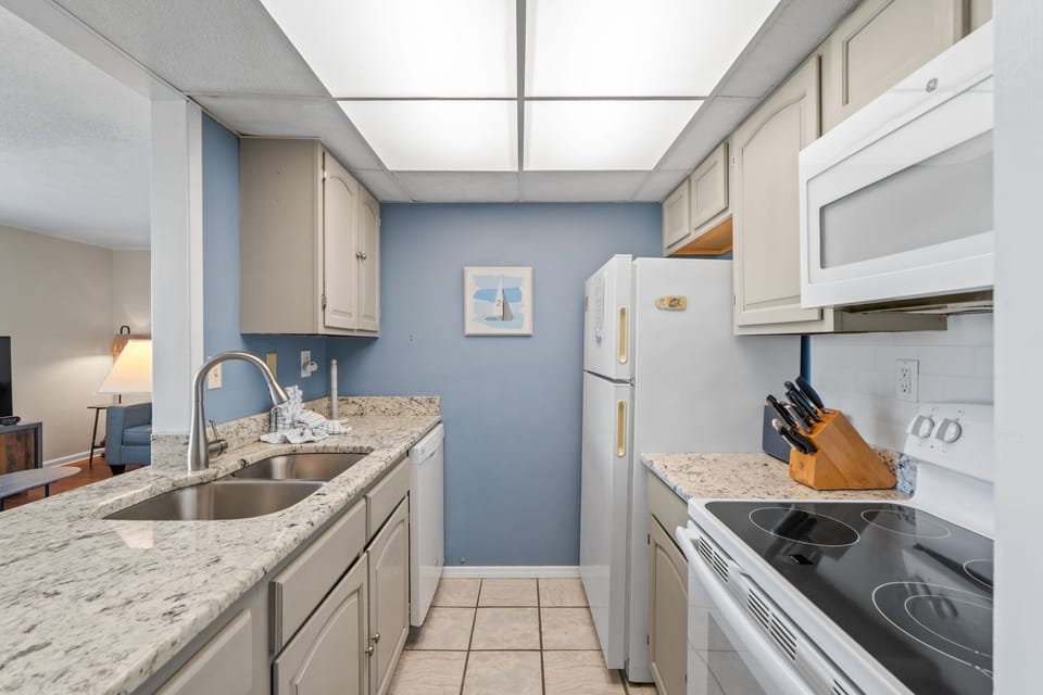 Prepare your favorite meals in this well-equipped kitchen featuring granite counters, full-size appliances, and everything you need for a comfortable stay.