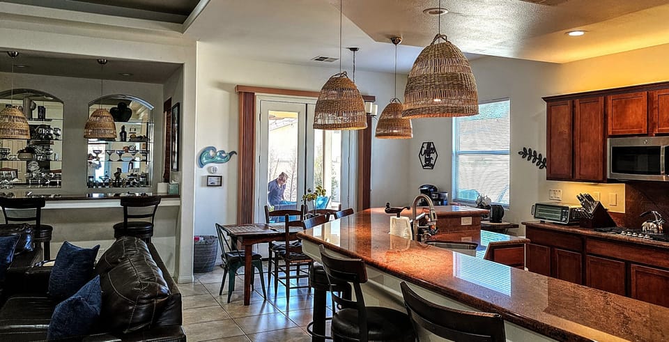 Elegant kitchen & bar, leading to inviting patio.