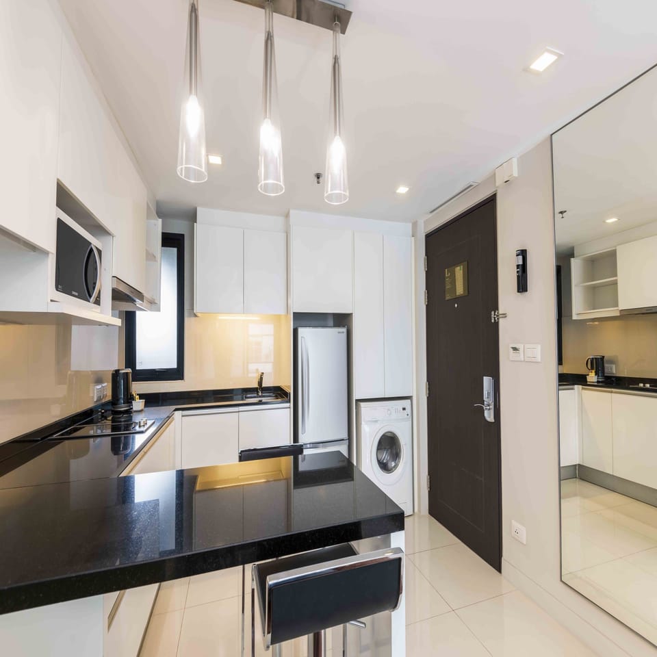 One Bedroom Deluxe | Private kitchen | Full-size fridge, microwave, stovetop, coffee/tea maker