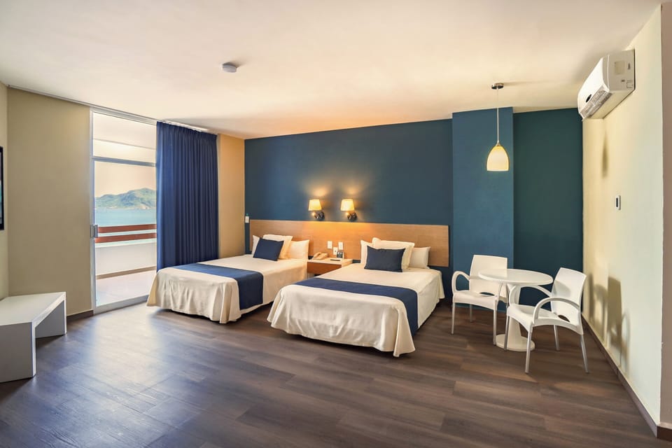 Standard Room, 2 Double Beds, Ocean View | In-room safe, blackout drapes, free cribs/infant beds, rollaway beds