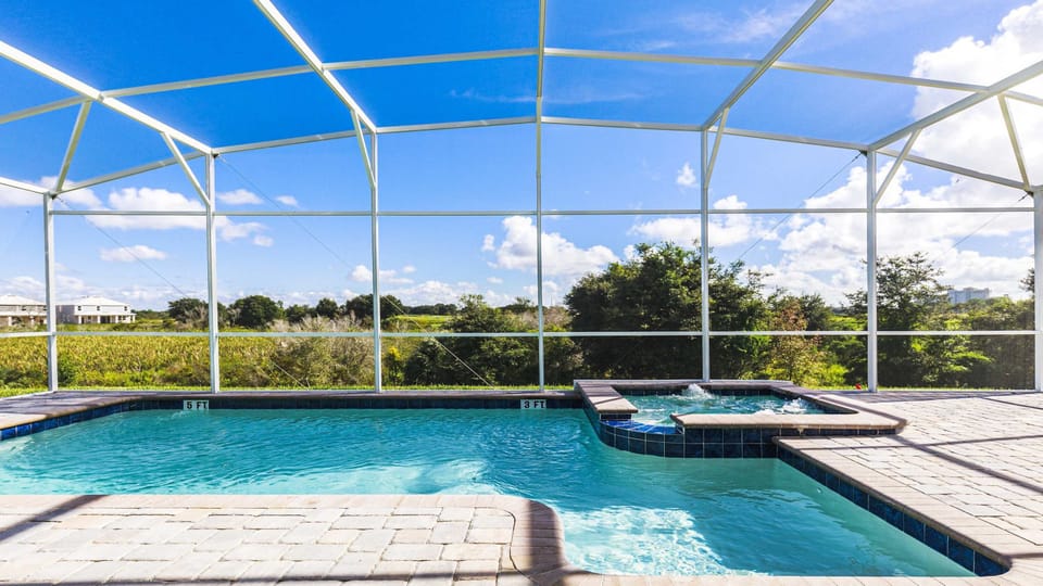 Private screened-in pool with spa, surrounded by scenic views and sunny skies.