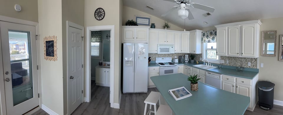 Well appointed kitchen with large center island and additional seating with bars