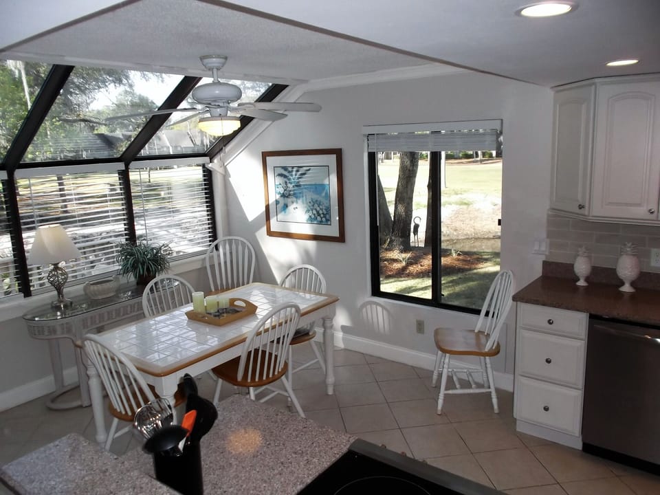 Sunny dining area for 6 with stunning panoramic view of lagoon and golf course. 