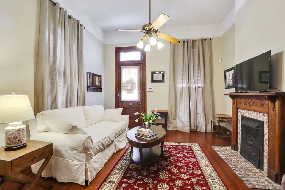 Living room with queen sofa sleeper and large flat screen TV.