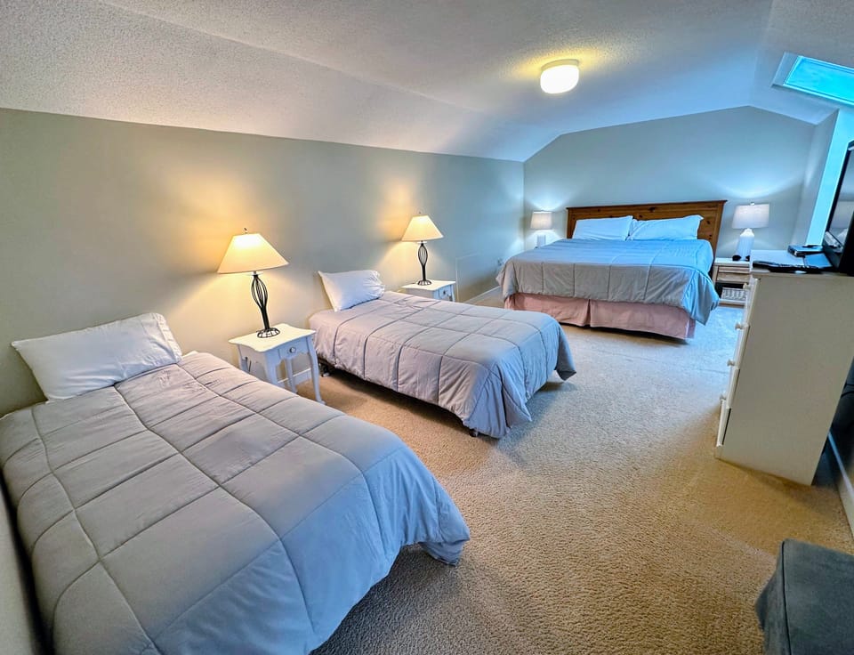 Loft bedroom - Located on the upper level with a king bed and two twin beds. Note, there is no sound-proofing from this space to the lower level.