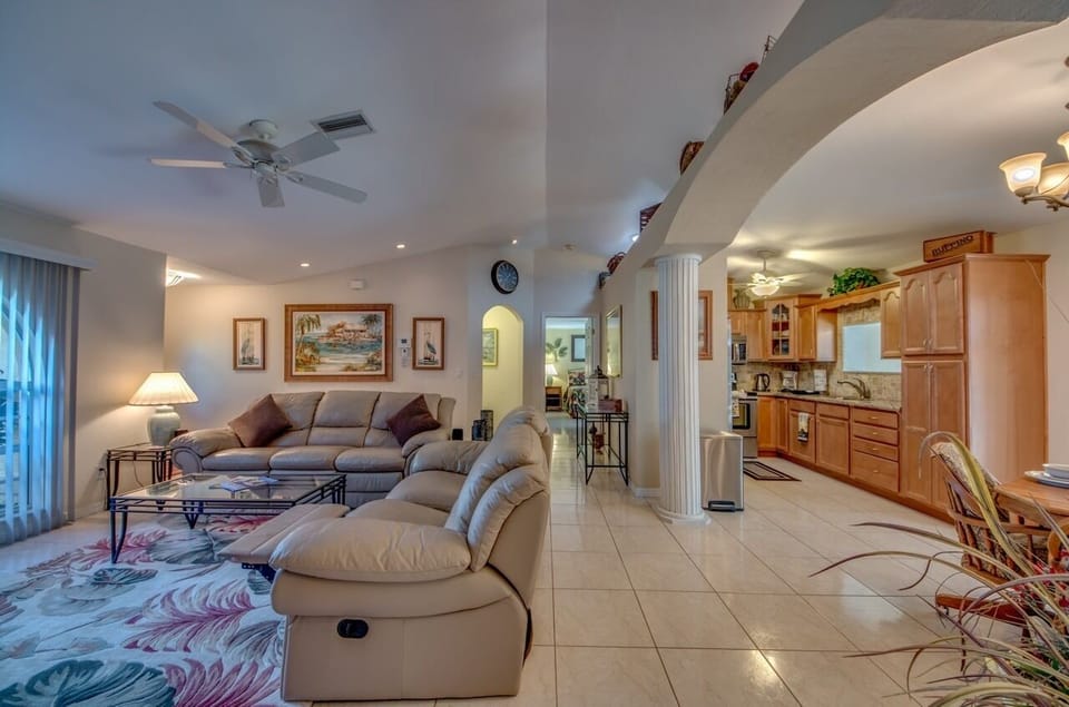 Open livingroom with smart TV and leather furniture