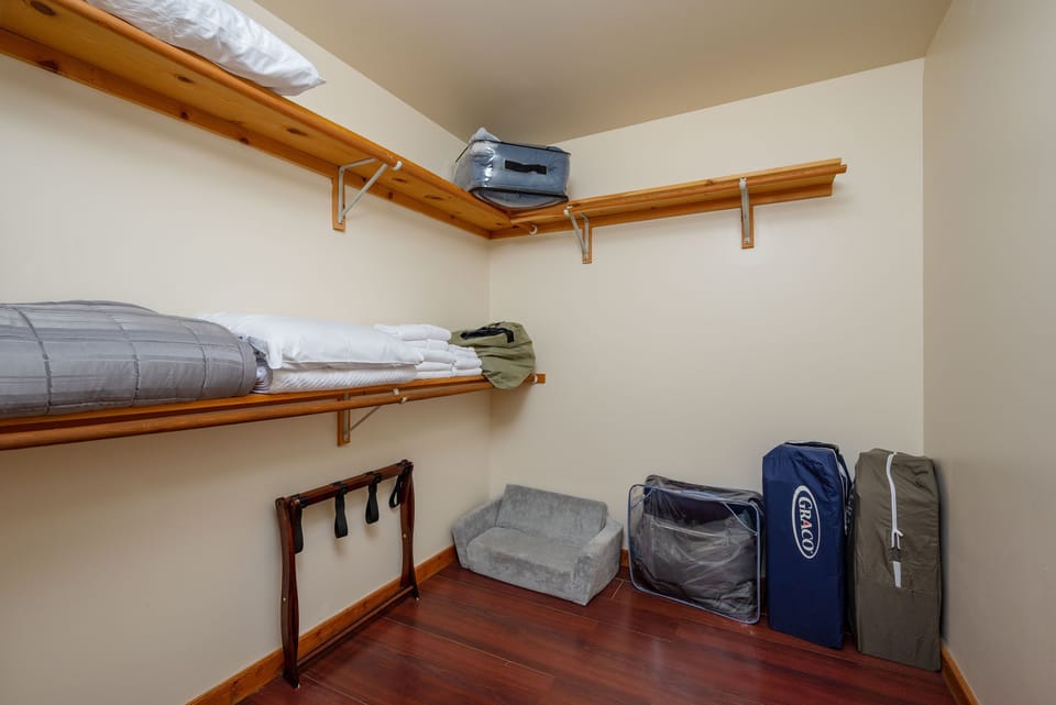 Spacious Walk-in closet with extra blankets, bedding, and play pens!