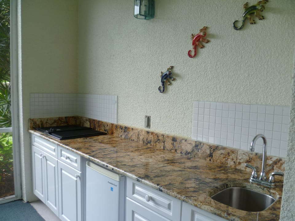 Outside kitchen, with new jenn-aire grille, fridge and wet bar/sink