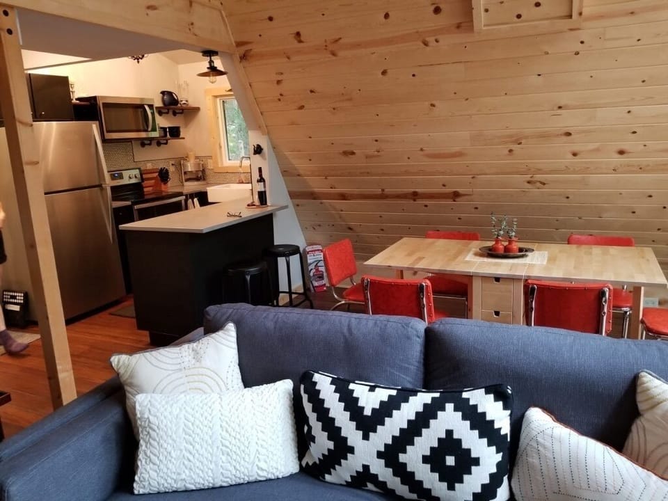 Modern, fully-equipped kitchen complete with breakfast bar opens into the spacious living/dining area.