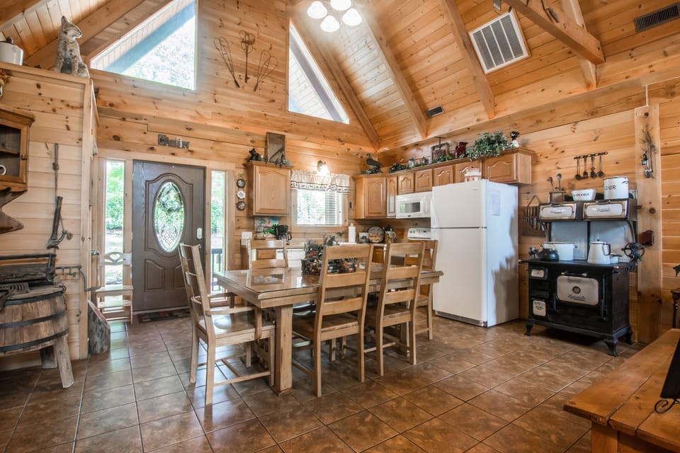Kitchen area with refrigerator, stove, microwave, & dishwasher.