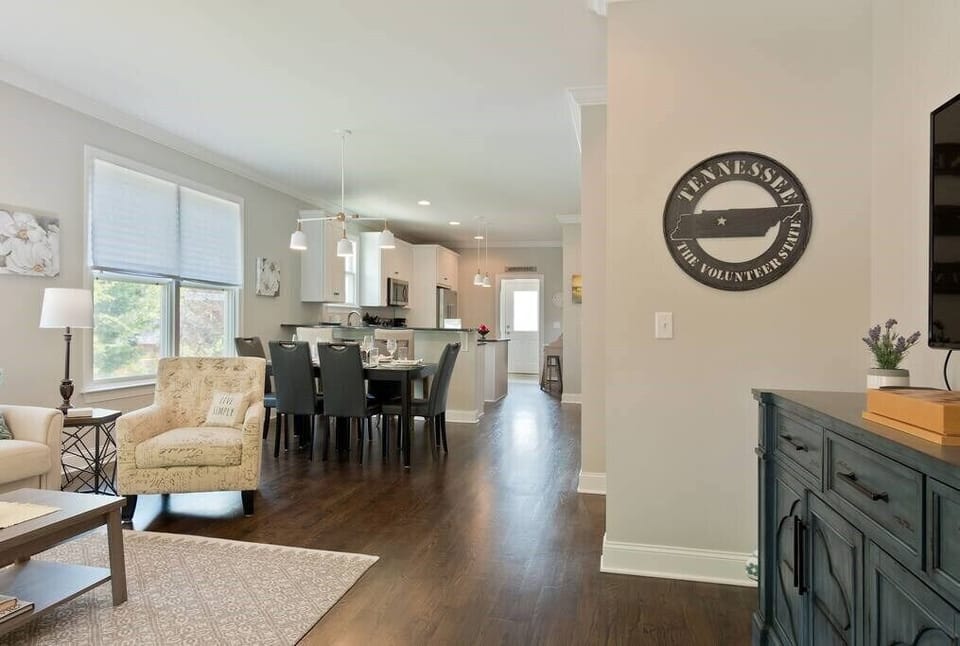 The spacious open floor plan connects the living room, dining area, and kitchen.