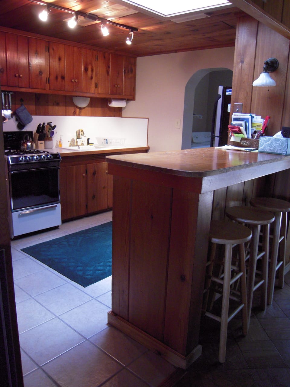 Spacious kitchen with washer and dryer in room behind.