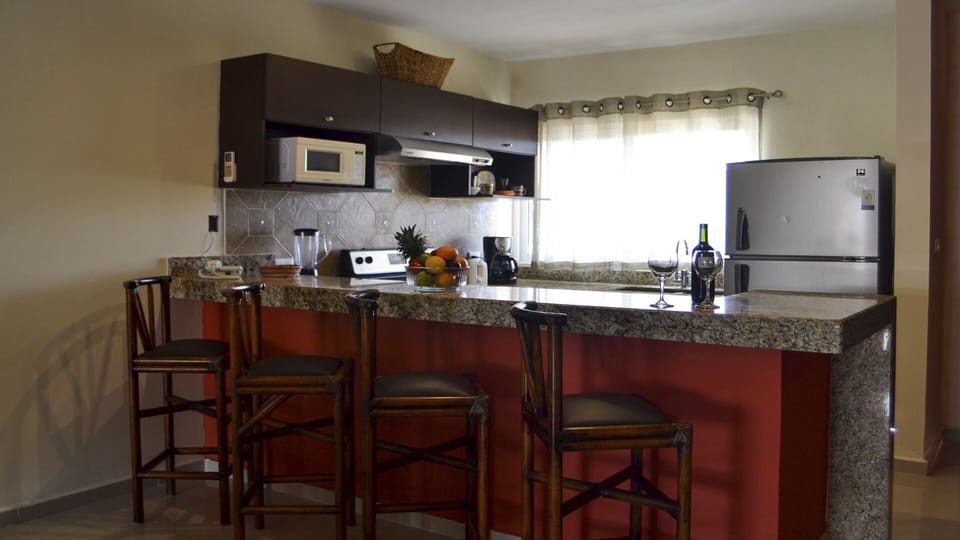 Fully-appointed kitchen with island seating area. 