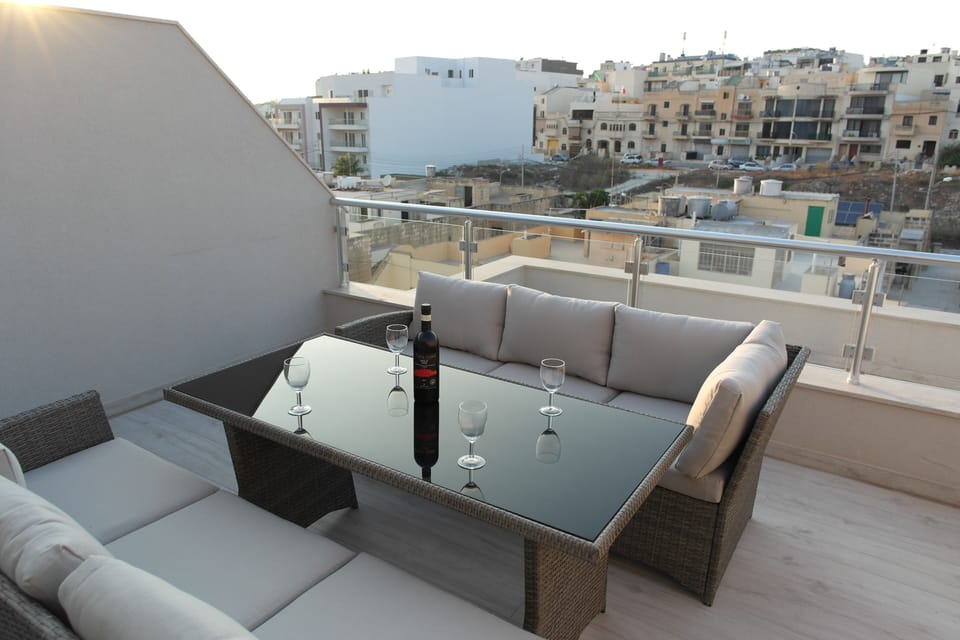 Enjoy a glass of wine and some Maltese snacks as you watch the sun go down