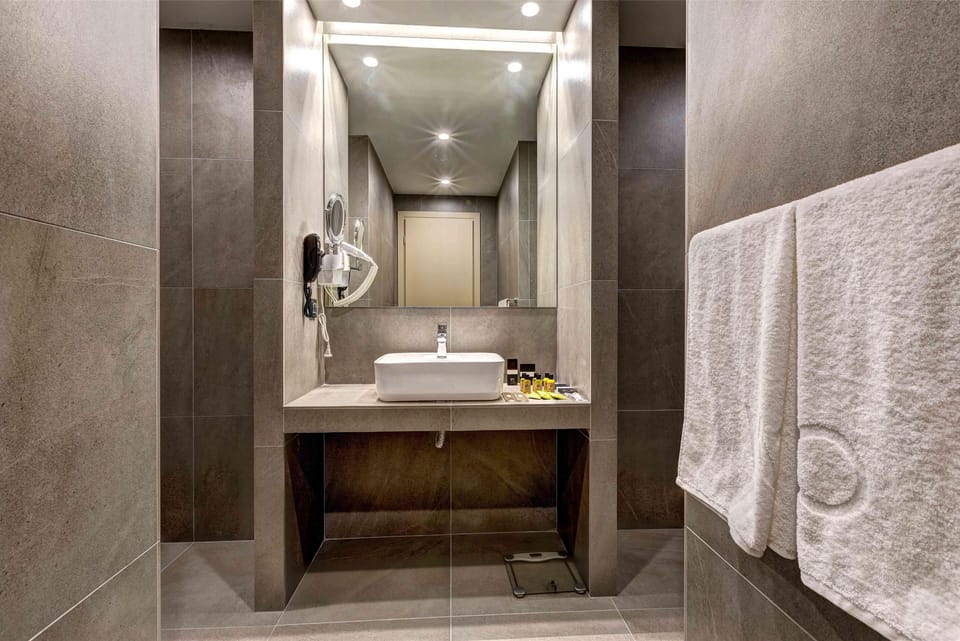 Shower, hair dryer, slippers, towels
