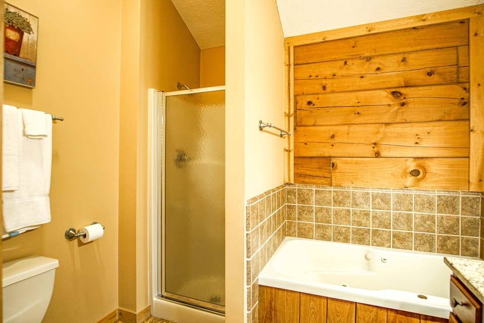 This is the master bathroom with a jacuzzi tub and a stand up shower.