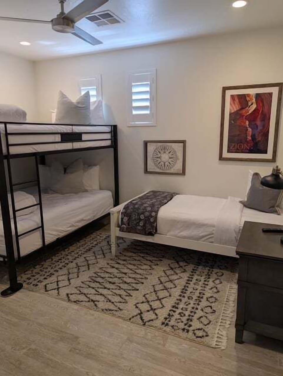 Fun bunk room with bed and twin bunk beds, perfect for kids, families, or group stays.