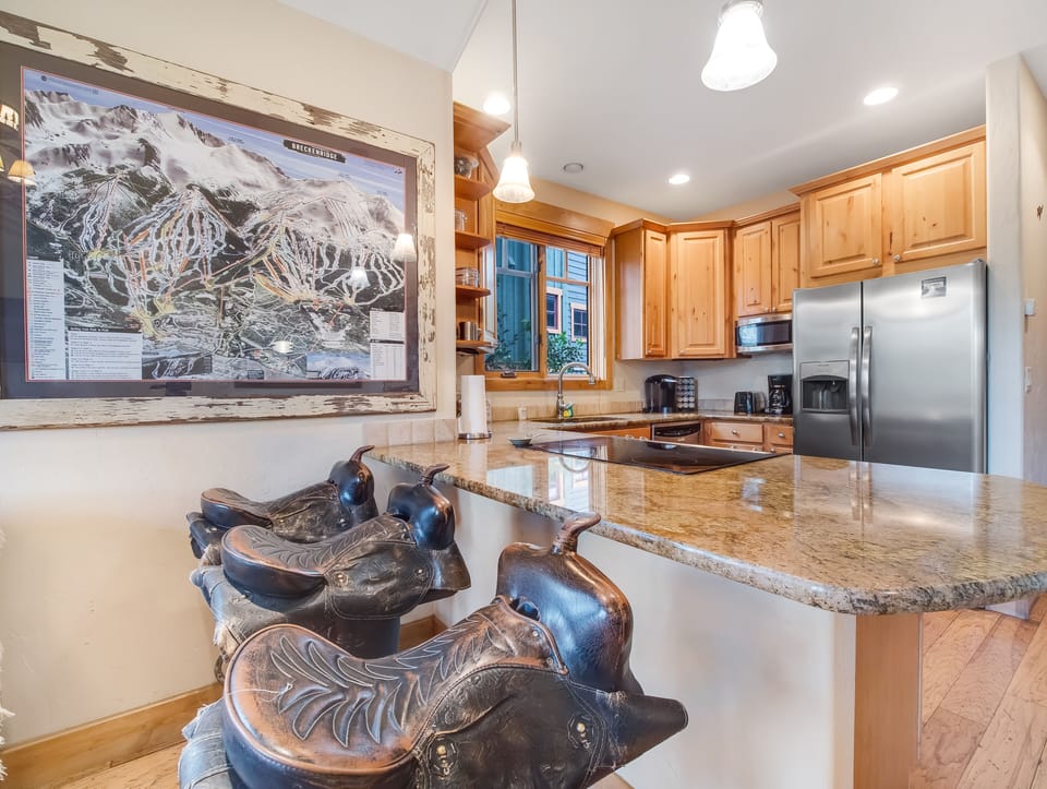 The three saddle barstools offer seating for 3.