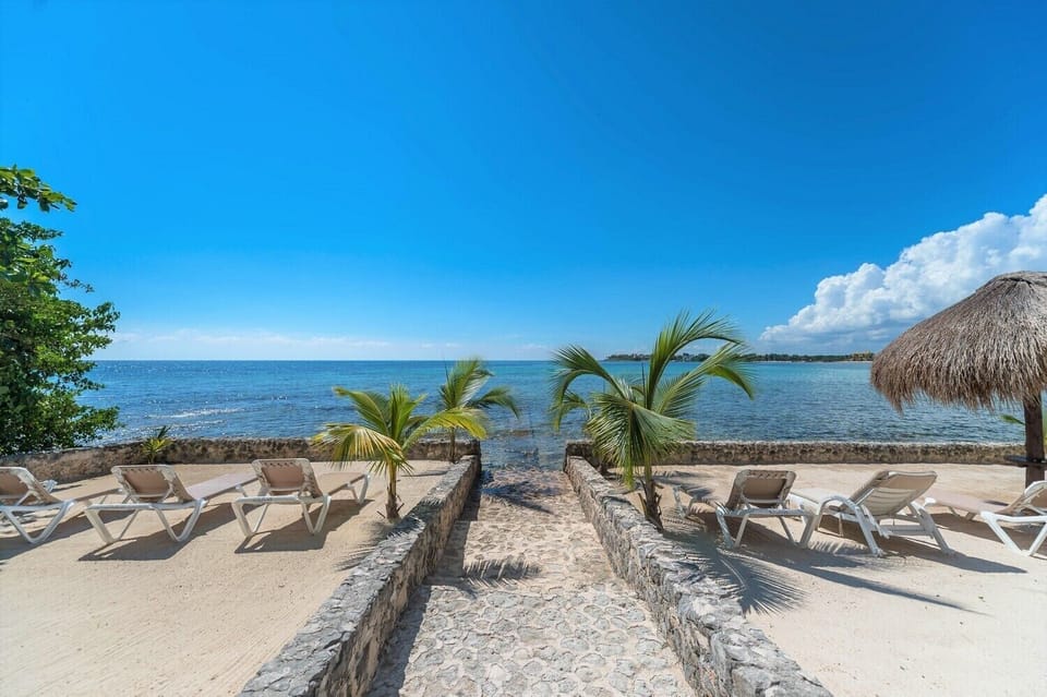 Loungers and shade palapas for guest use - La Iguana condo 4, 1 bedroom Akumal vacation rental Akumal Mexico vacation rental