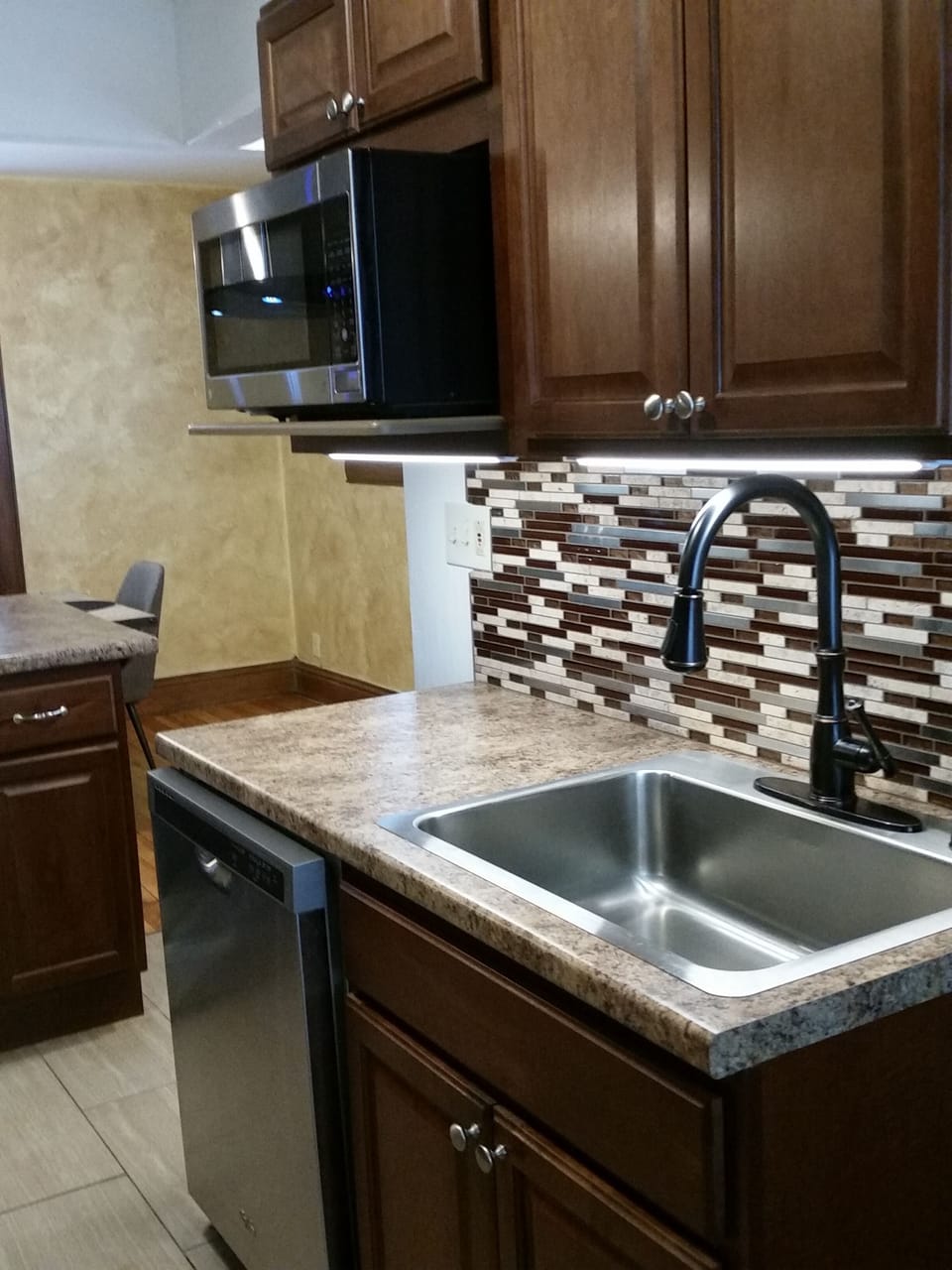 Under cabinet lighting; new stainless dishwasher, microwave, fridge