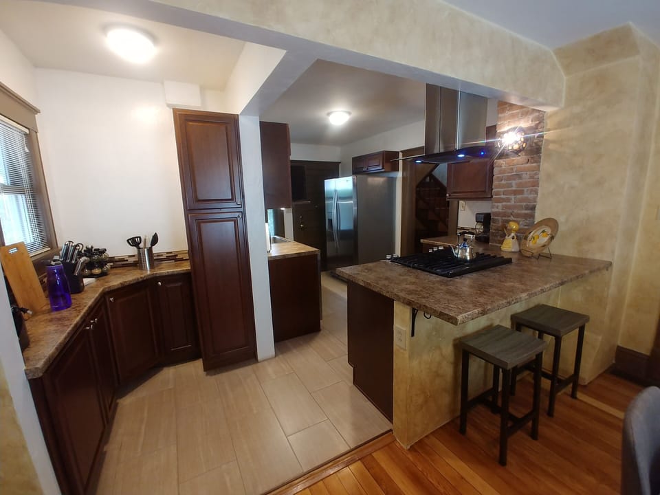 View of pantry, kitchen, breakfast bar
