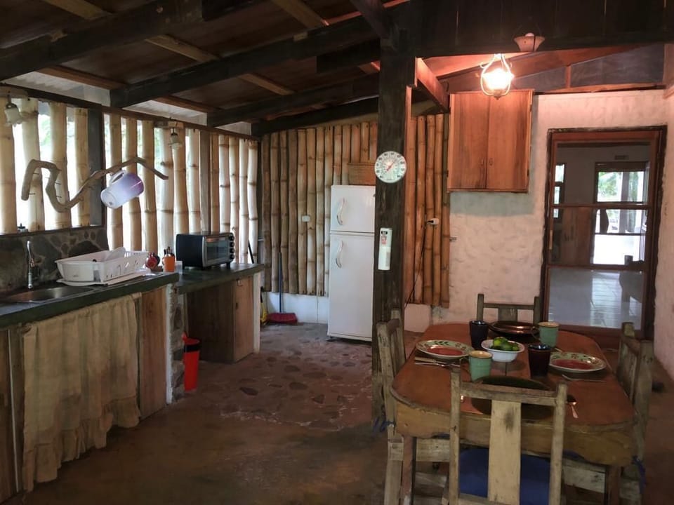 Our spacious kitchen, completely screened, admits fresh breezes and river sounds