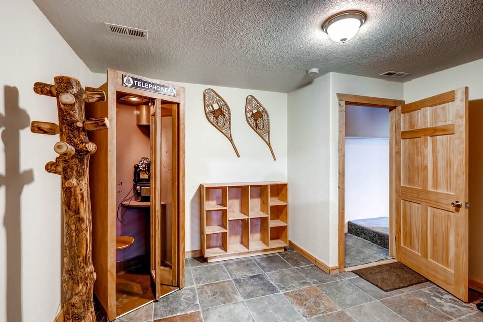Mudroom for gear storage. And antique phone booth!