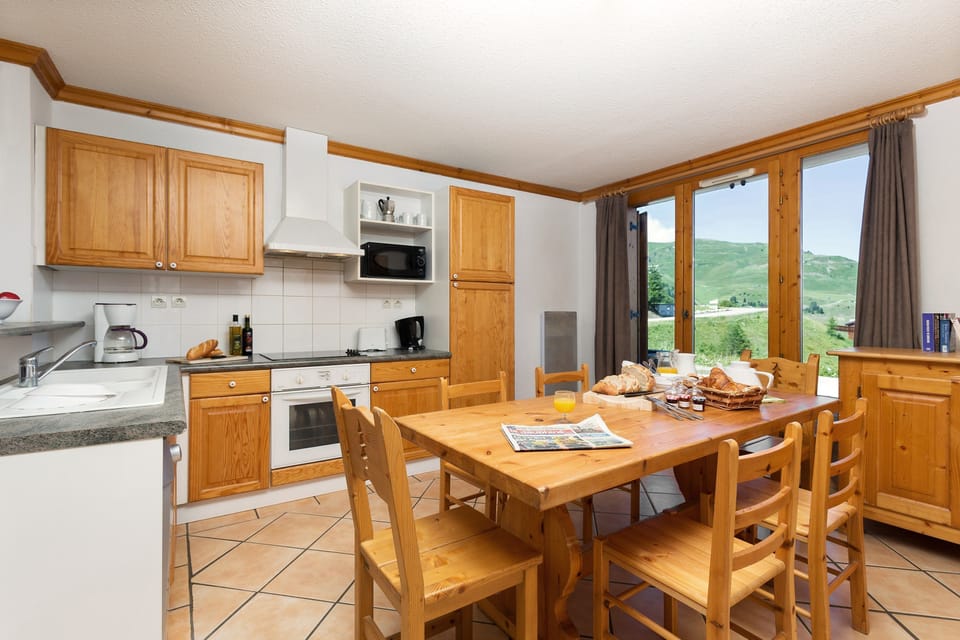Enjoy your meals at the elegant dining table with seating.