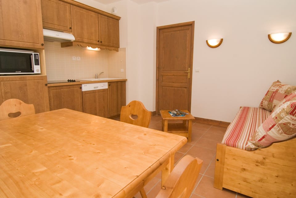 Prepare meals in the kitchenette and enjoy them at the dining table.