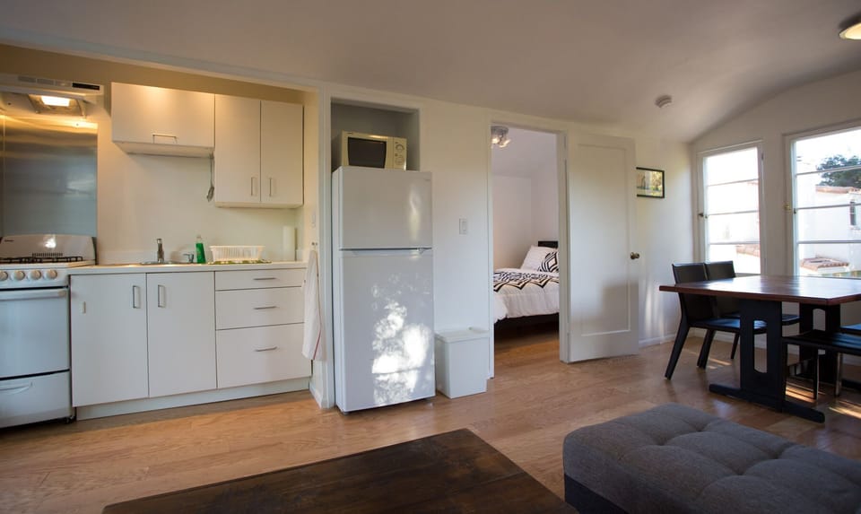 A light and airy living space with a fully equipped kitchen.