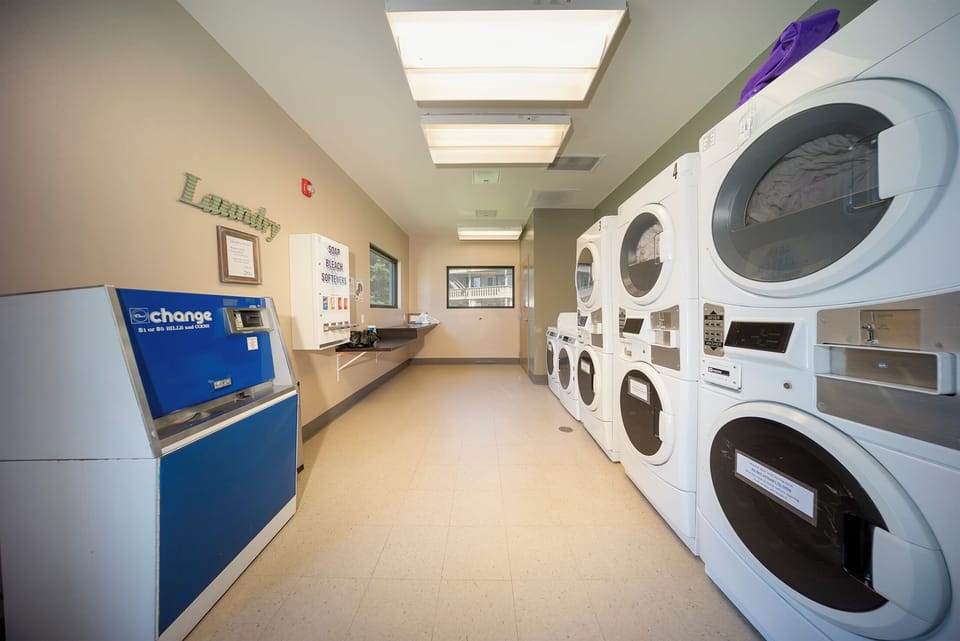 Keep your wardrobe fresh in our well-lit laundry facility with multiple machines and convenient change service.