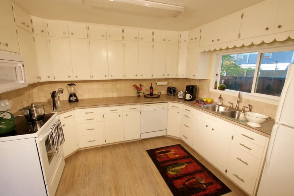 Kitchen with oven, induction stove, refrigerator, and microwave