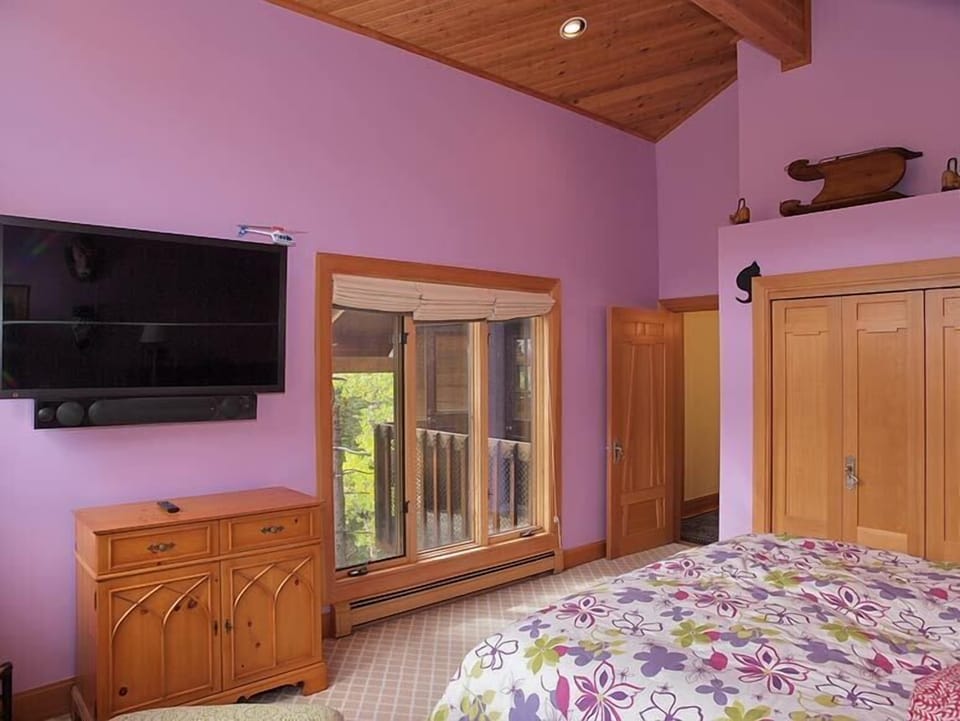 Purple Bedroom: TV and sound system, closets and creekside view.