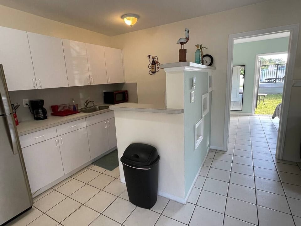 Kitchen is on the left, bedroom and outside are through the doorway, and the living room is to the right (not visible in the picture).