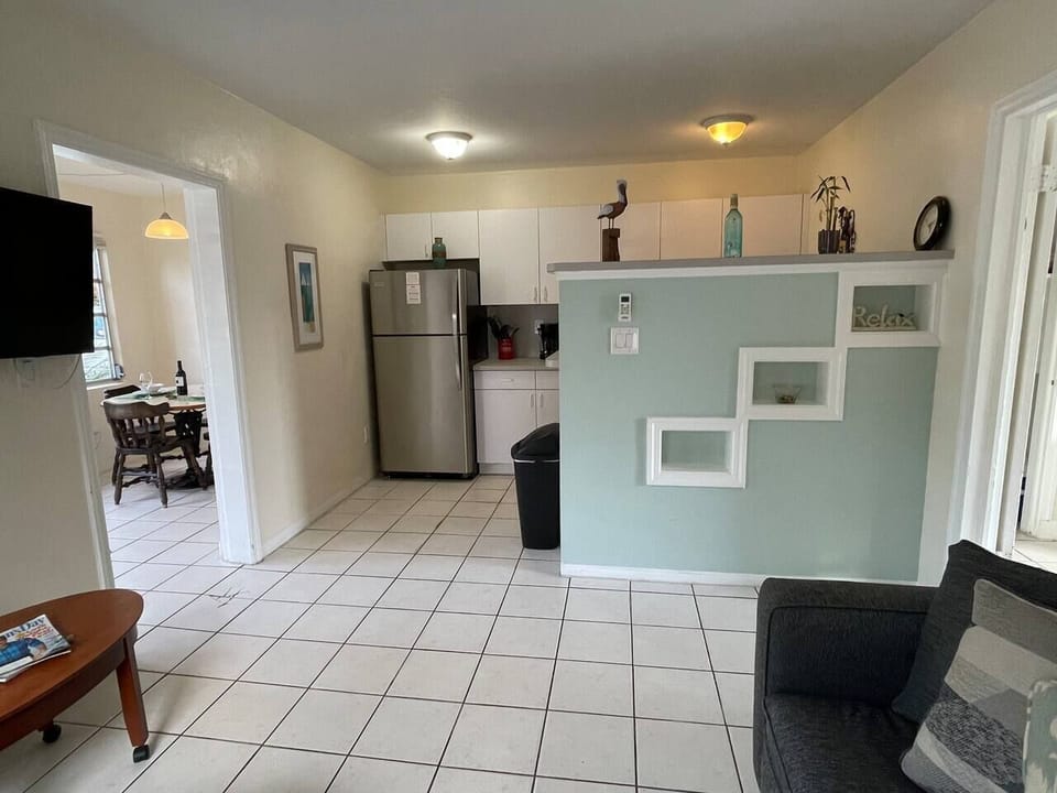 Looking from the living room to the kitchen. On the left:  doorway to the front room.  On the right:  doorway to the bedroom.