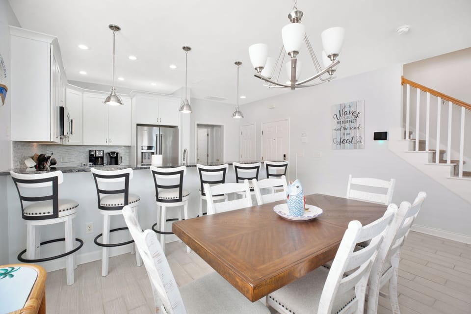 New coastal-style dining table, chairs and bar stools in the dining/kitchen area