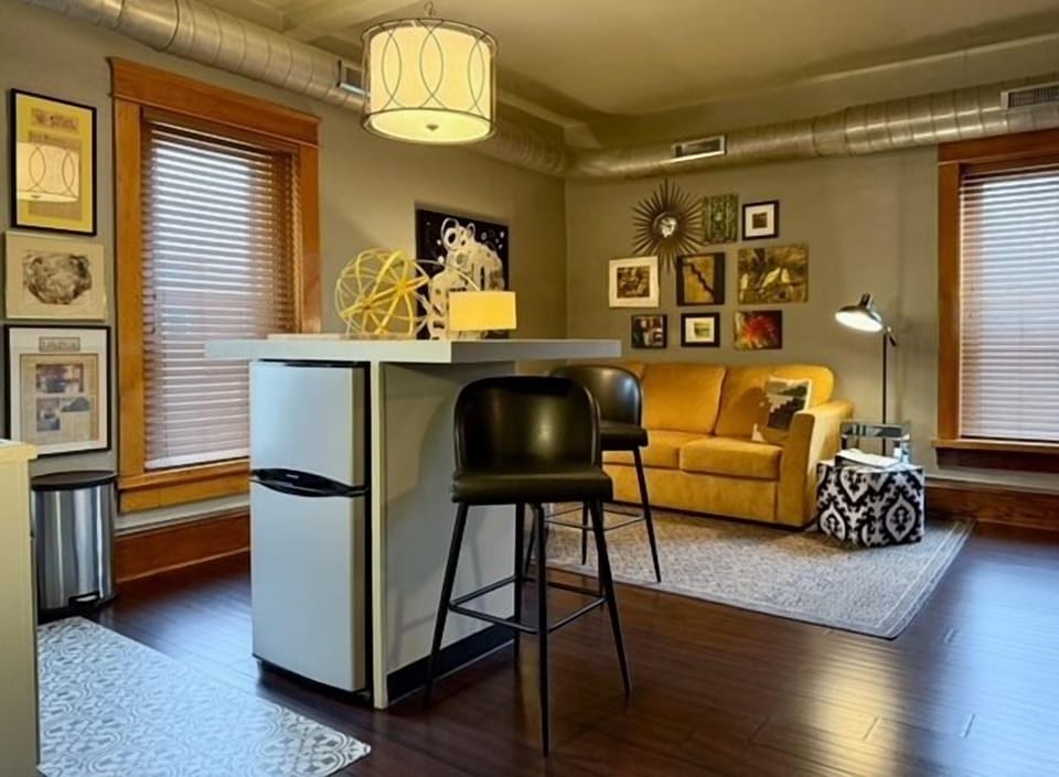 The apartment-size fridge is under the island.