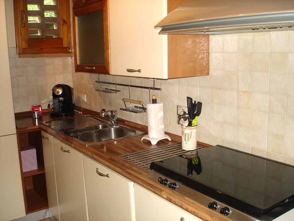 Kitchen with dishwasher, microwave, oven, toaster, espresso machine
