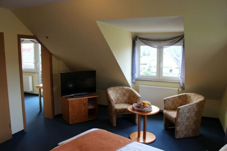 Quadruple Room | Living area | Flat-screen TV