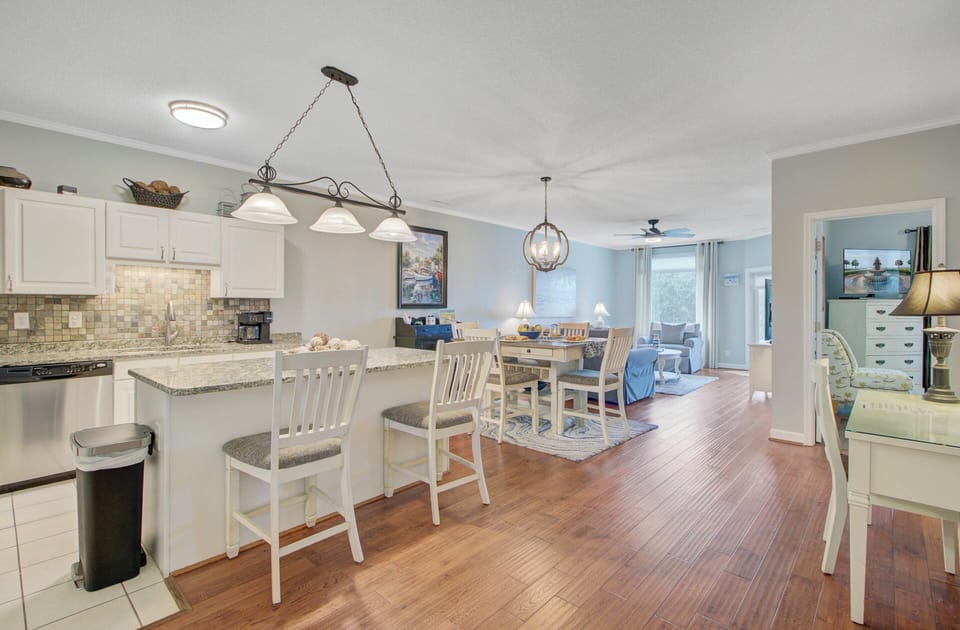 Your open-concept space flows seamlessly from the granite kitchen island to your comfortable living area, creating the perfect setting for relaxed vacation meals.