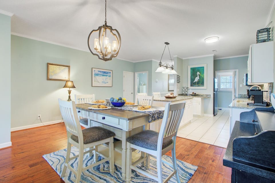 Gather around your elegant dining table for memorable meals with loved ones in this bright, coastal-inspired space.