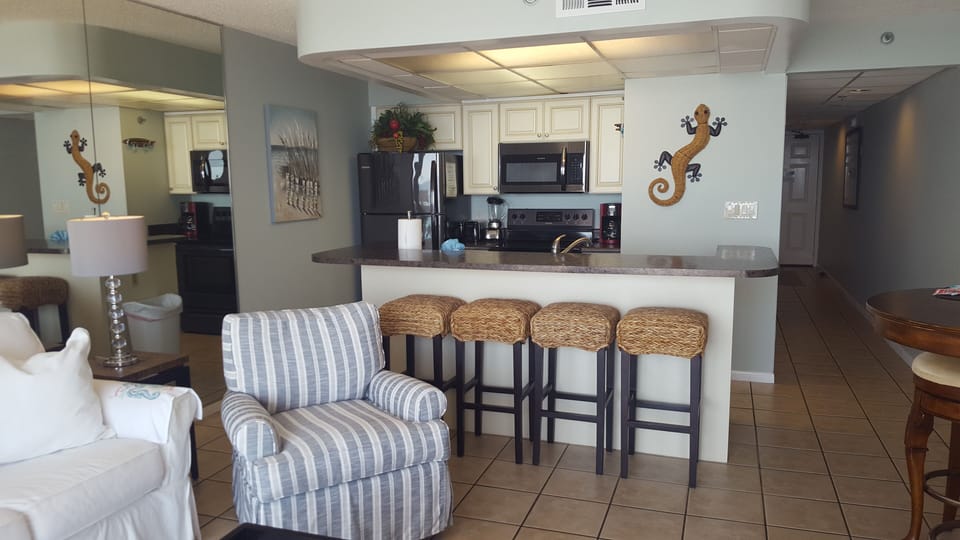 Kitchen with black stainless appliances and bar seating for four.