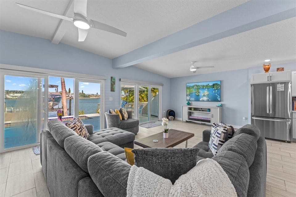 Bright, spacious and cozy living room area with a huge couch where you can enjoy watching your favorite shows, and spending time with the family