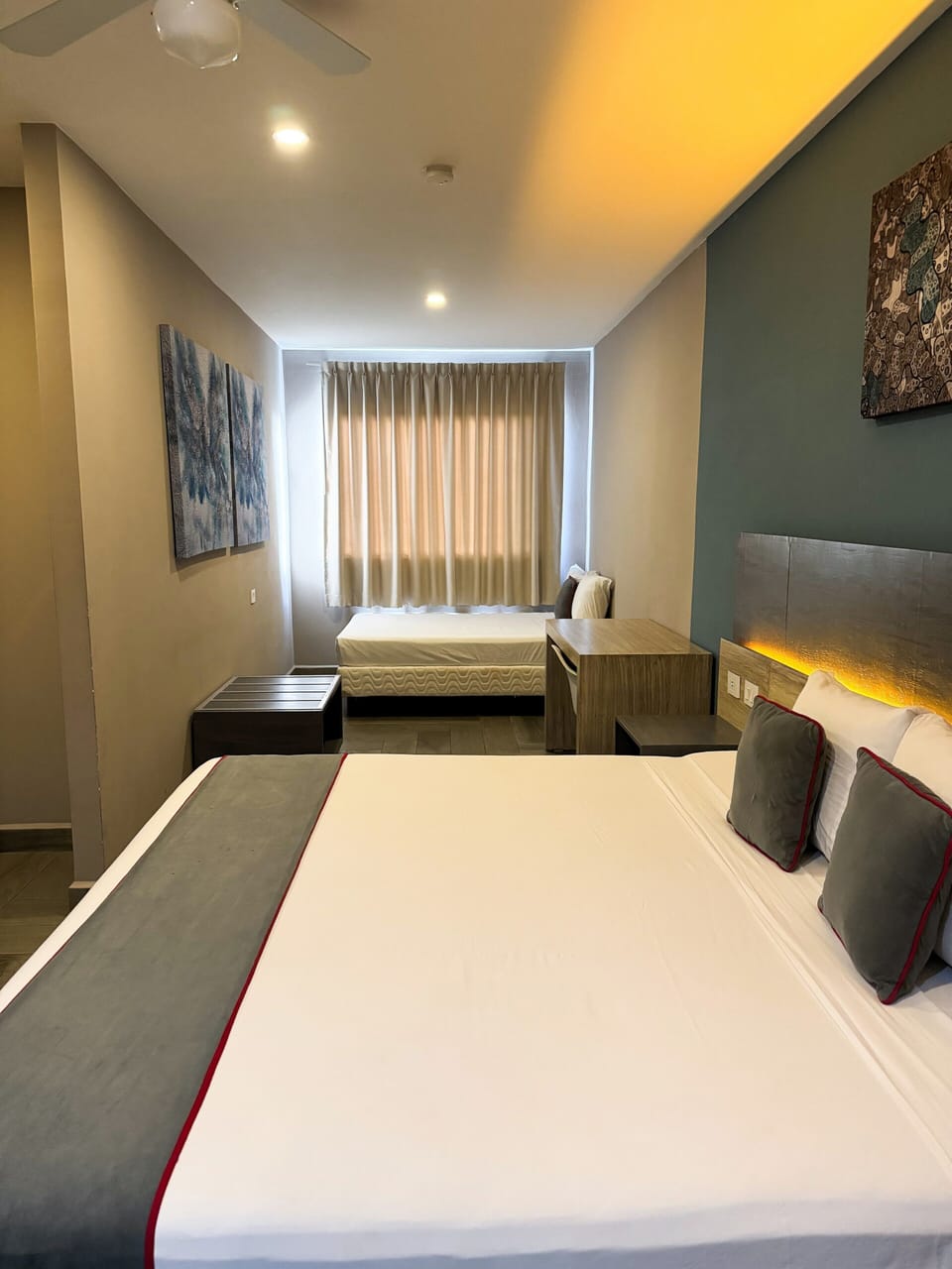 Deluxe Quadruple Room | Minibar, in-room safe, desk, laptop workspace