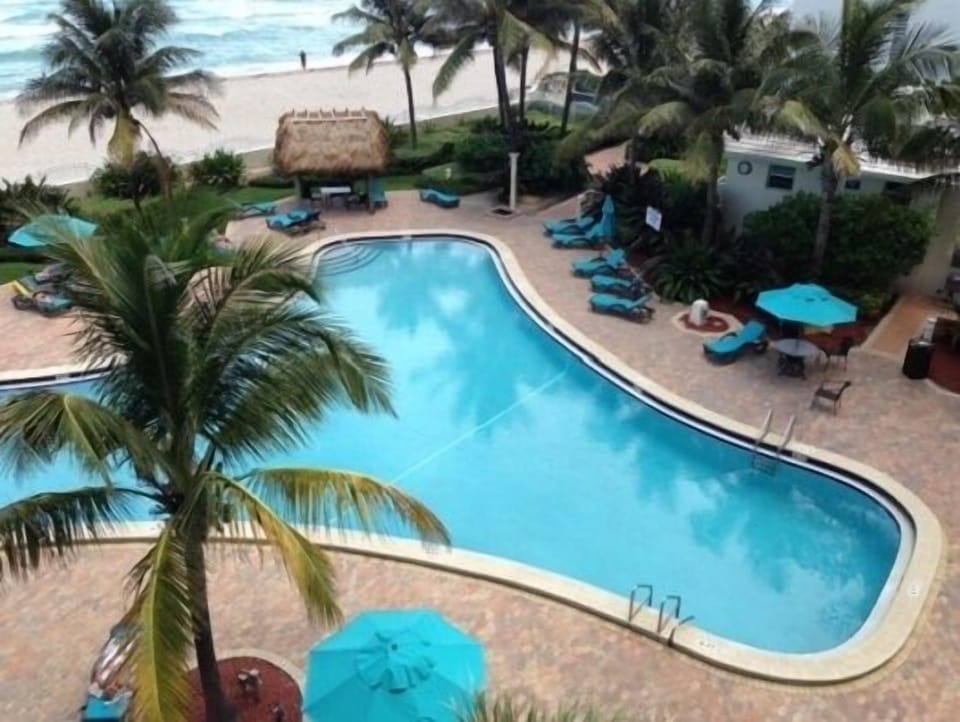Pool deck with beach- ocean in background (not view from unit)